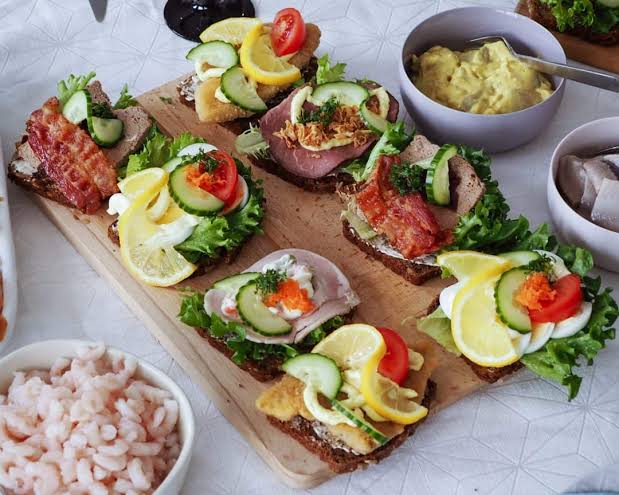 FooDriver_dApp's tweet photo. Smørrebrød: Denmark's Iconic Open-Faced Sandwich

The quintessential Danish dish, smørrebrød features dense rye bread piled high with an array of toppings - from cold cuts and cheese to seafood and produce. The key lies in harmonizing flavors and textures into a visually striking presentation. This centuries-old culinary tradition continues to be a revered staple of Danish cuisine.