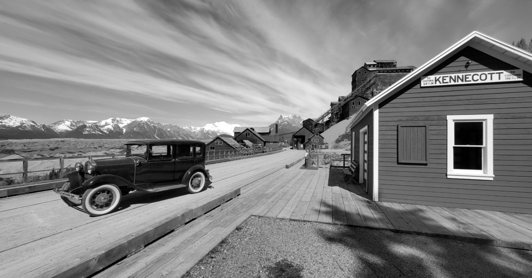 Kennecott past or present? Do you have a black and white then and now photograph to share? 
Photo courtesy of Mark Cosson, NPS Maintenance at Wrangell-St. Elias /Vintage car next to the Kennecott train depot.