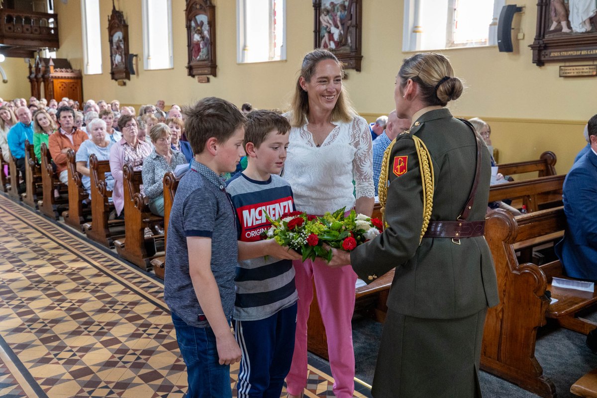 LiamdePaor's tweet photo. Commandant Claire Mortimer, ADC to An Taoiseach at #EmbraceFARM, Remembrance Service in the Church of the Most Holy Rosary, Abbeyleix, Sun 30th June 2024 presents a wreath to the Banville family from Co. Wxxford in memory of Kevin a dear husband to Diane & dad to Ryan & Cillian https://t.co/h3VYcmjmbi