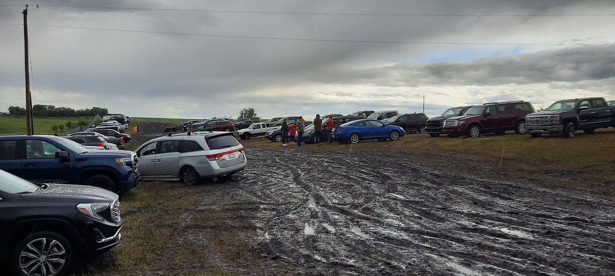 TimKalFree's tweet photo. Airdrie Pro Rodeo continues but parking area is a bit of a quagmire. Several vehicles stuck in the mud. @RockyViewCounty @AirdrieCityView https://t.co/b95NsYMDto