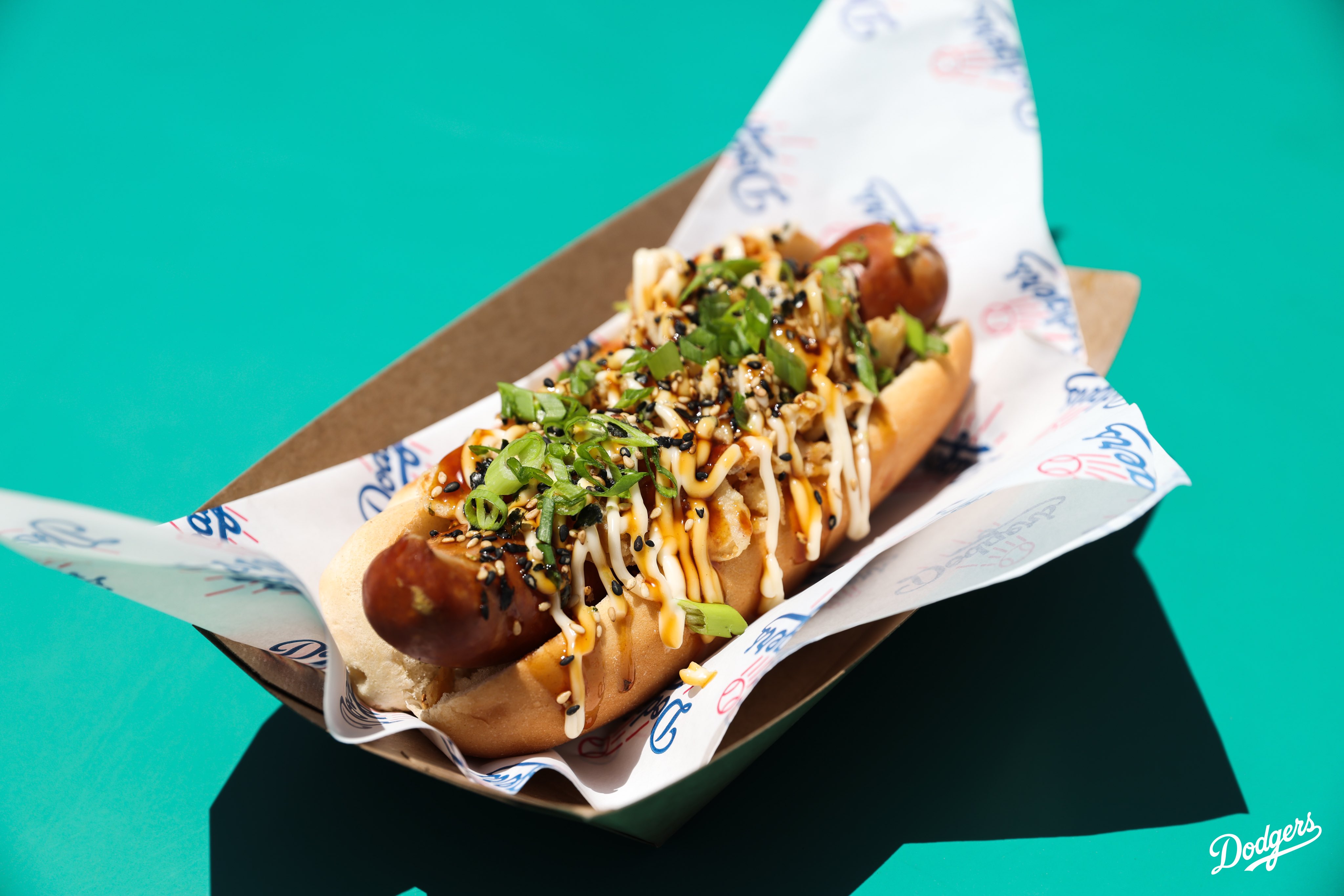 A photo of a Kuraboto Pork Sausage. 

Here’s where you can find all the food items: 
•Takoyaki: Field 45⁣
•Chicken Katsu Sandwich: Field 8⁣
•Homerun Platter: Field 8⁣
•Kurobuta Pork Terimayo Dog: Field 8, LA Feeds Blue (next to Gold Glove), Reserve 4⁣
•Chef Merito Ponzu Asada Fries: Field 52, Reserve 17⁣
•Tofu Yakisoba Bowl: Field 45⁣
•Chicken Katsu Curry Bowl: Field 45, Reserve 4⁣
•Mochi Ice Cream: Field 8, LA Feeds Blue (next to Gold Glove)⁣
