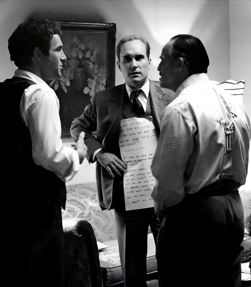 Robert Duvall wearing cue cards for Marlon Brando to read his lines during the filming of 'The Godfather' (1972).