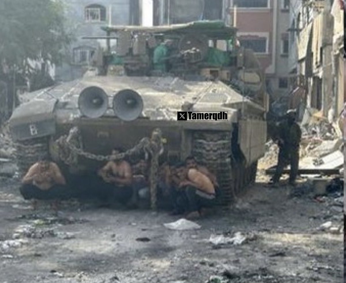 A recently posted image from an Israeli soldier in Gaza shows Israeli occupation forces using Palestinian civilians as human shields, placing them naked in front of their armored vehicles during their invasion.