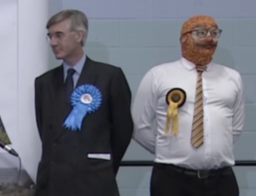 meanwhile, Jacob Rees-Mogg has lost his seat to Labour while standing next to a man wearing a baked beans balaclava
