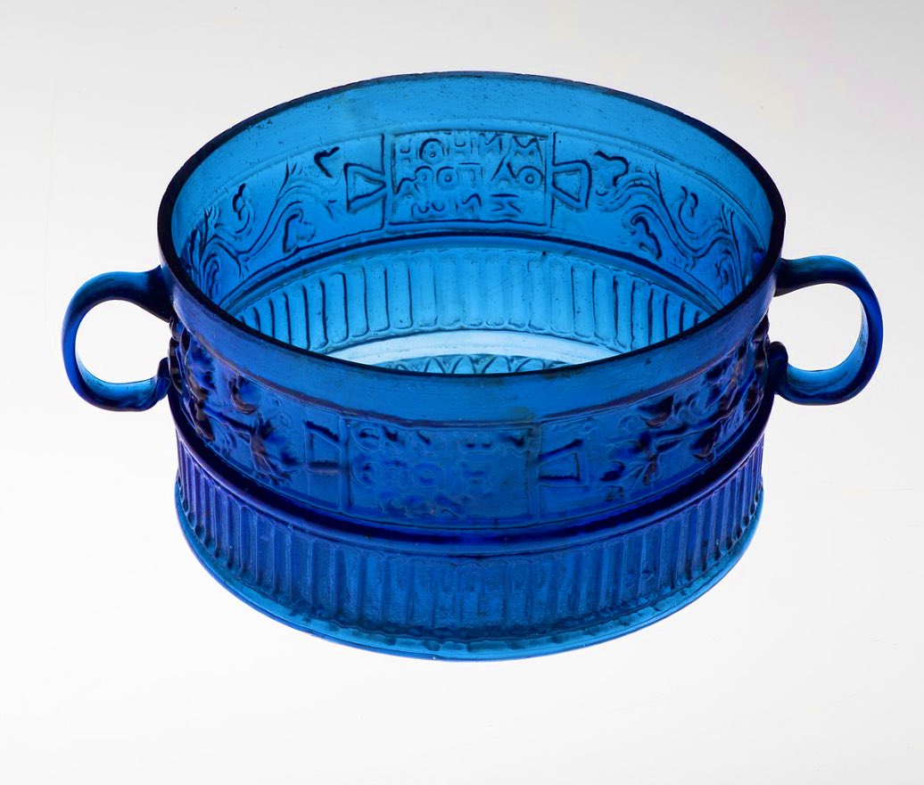 #FindsFriday

An exquisite Roman-era cobalt blue glass cup signed by the master glassmaker ‘Ennion’. AD 30-70.

By incorporating his name into the mould’s design, Ennion was the first glassmaker to ‘brand’ his work. 

This luxury cup is one of a matching pair made from the same