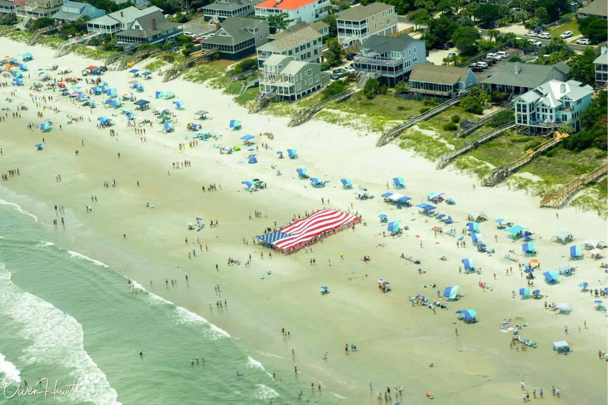 EdPiotrowski's tweet photo. This is a cool photo! @OwenAviation was flying in the navy blue Navion marked Marines and captured this image of a giant American flag on the beach in Pawleys Island. In total, #SaluteFromtheShore was amazing with two F-16s and warbirds from 10 eras.  #4thofJuly https://t.co/eVFDJQ96fH