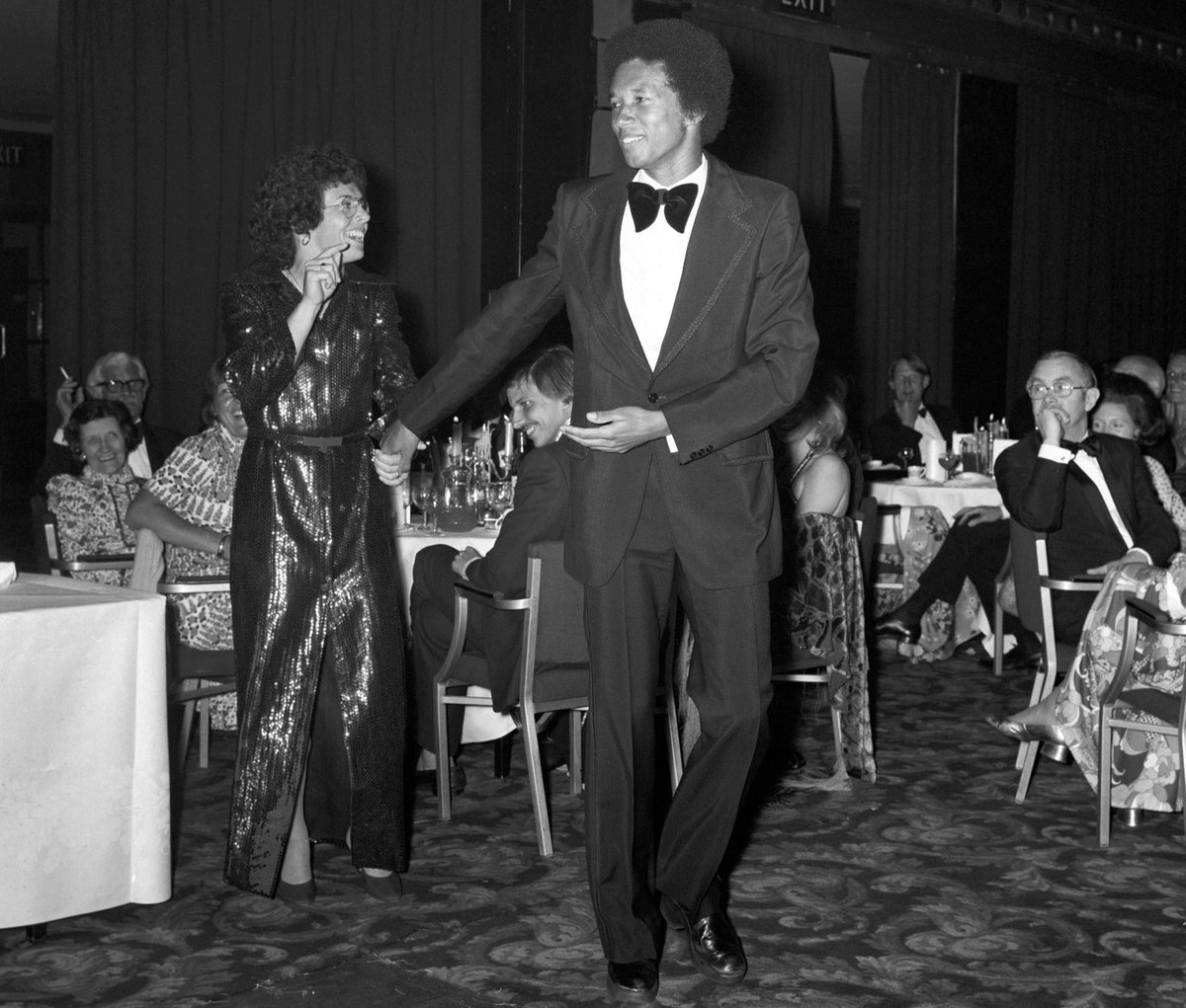 BillieJeanKing's tweet image. On July 5, 1975, 49 years ago today, Arthur Ashe became the first Black man to win a #Wimbledon singles title.

I won the Wimbledon women's singles title the same year, and we shared a dance together at the ball. 

#FlashbackFriday 

📷: Alamy