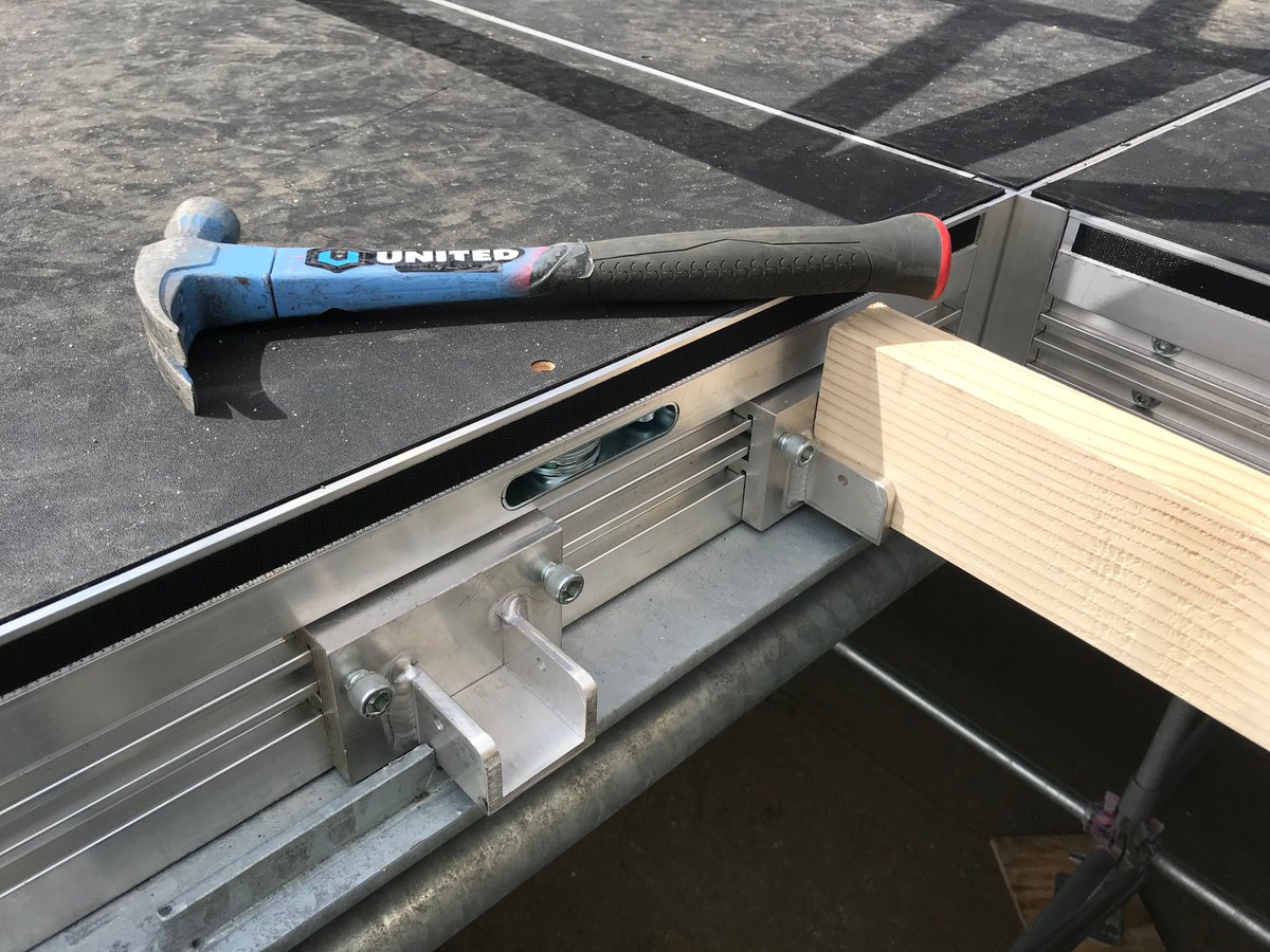 UnitedStaging's tweet image. One benefit of UNI-DECs, is that they make it easier to securely cover the stage gaps around the vertical truss towers.  
Attach joist hangers to the perimeter extrusions to hold 2x4s. Then screw plywood on top. 

Learn more: buff.ly/4cpvJ6B 

#stagetech #stageproduction