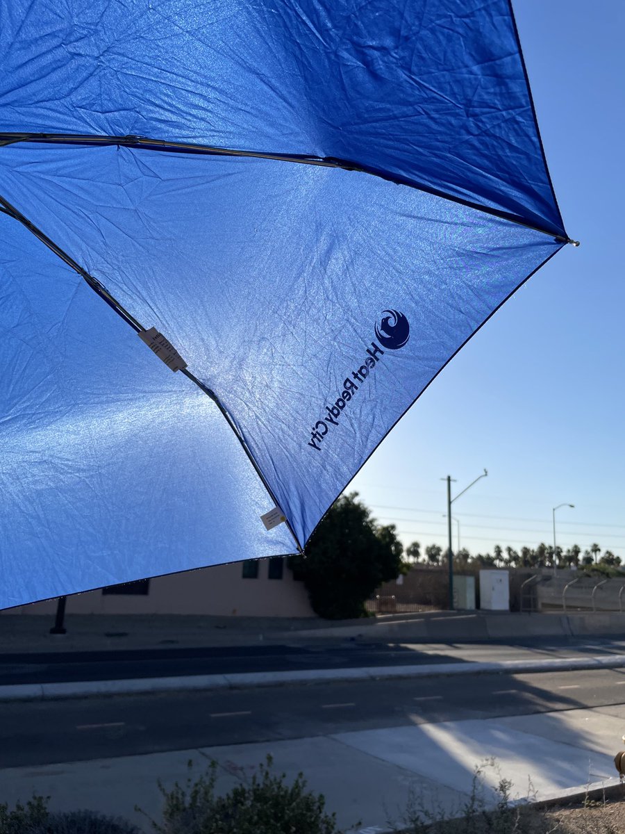MichaelDHammett's tweet photo. Walking in downtown ⁦@CityofPhoenixAZ⁩ today 112-115 degree temps. This UV umbrella from the HeatReady testing phase 2018 ⁦@BloombergDotOrg⁩ #MayorsChallenge (and refillable water bottle) still does the job! Personal #shade ⁦@HeatReadyPHX⁩ https://t.co/xT3Mk1XVik