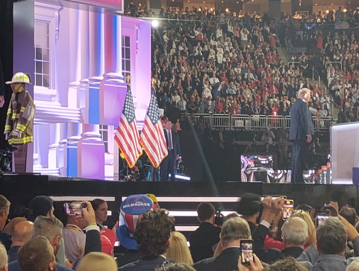 Dame4VT's tweet photo. #RNCConvention2024 
Just behind Trump (left corner of picture) is a reminder of the supporter who was killed by the would be assassin 
-who was a firefighter https://t.co/ycHQHvd96o