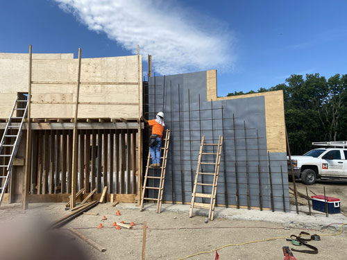 Work at the Allegawaho Memorial Heritage Park in Council Grove, KS on the sacred red rock relocation project is moving along. Marty Criqui, job superintendent, is managing crews currently forming the first of 2 poured-in-place curved walls located in front of the Welcome Center.