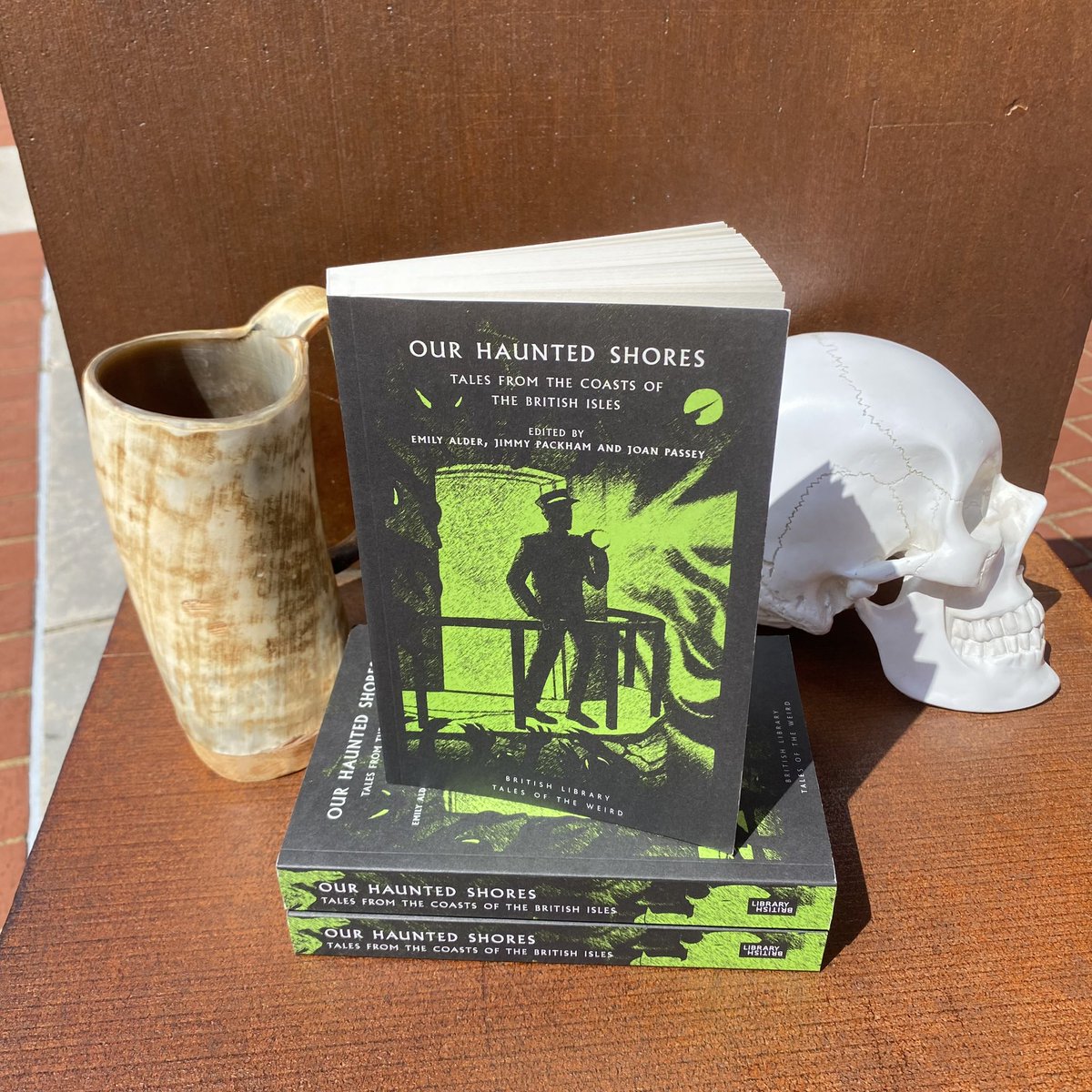 BL_Publishing's tweet photo. Congratulations to Our Haunted Shores! The winner of #TheUncannyCup. Here is the book receiving the Uncanny Cup itself. Well done @JoanPassey @Emilyalder @jfpackham. Thanks to everyone that played! Don’t forget all the #TalesoftheWeird books are on 3for2 @BL_Shop. Stay Weird. https://t.co/VZbYutTIDq