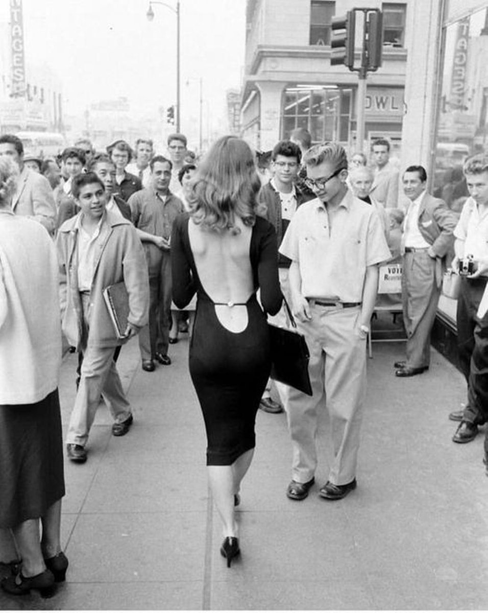 Paolo1264's tweet photo. Ralph Crane, Vikki Dougan walking through the streets of Hollywood in a beckless black dressconsidered to be 'daring' and 'scandalous' at the time. https://t.co/NleZzovzEJ