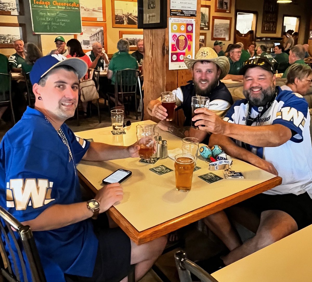 TheBushwakker's tweet photo. Nice to see a little splash of Blue in a Sea of Green! Bomber fans and Rider fans come together at the Bushwakker for some friendly banter and good company. Enjoy our gourmet BOMBER BURGER &amp; a PINT special before the 7:30 kickoff. Come “devour” the competition! #bushwakkerbrewpub https://t.co/9ZUE47Vc8v