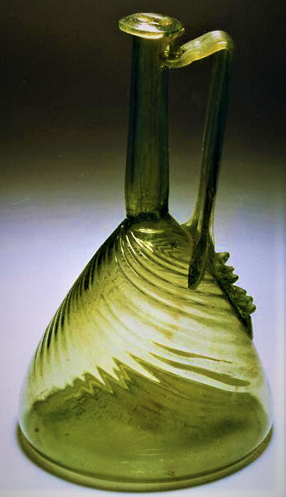 TrimontiumTrust's tweet photo. Very rare find - a complete and intact #Roman glass jug found near Turriff, #Aberdeenshire, #Scotland, dating to 80-150AD. Made from blown glass, it has a long narrow neck with an out turned rim. It has fine diagonal ribbing on the body, while the long handle has a vertical rib. https://t.co/sXIISMpowD