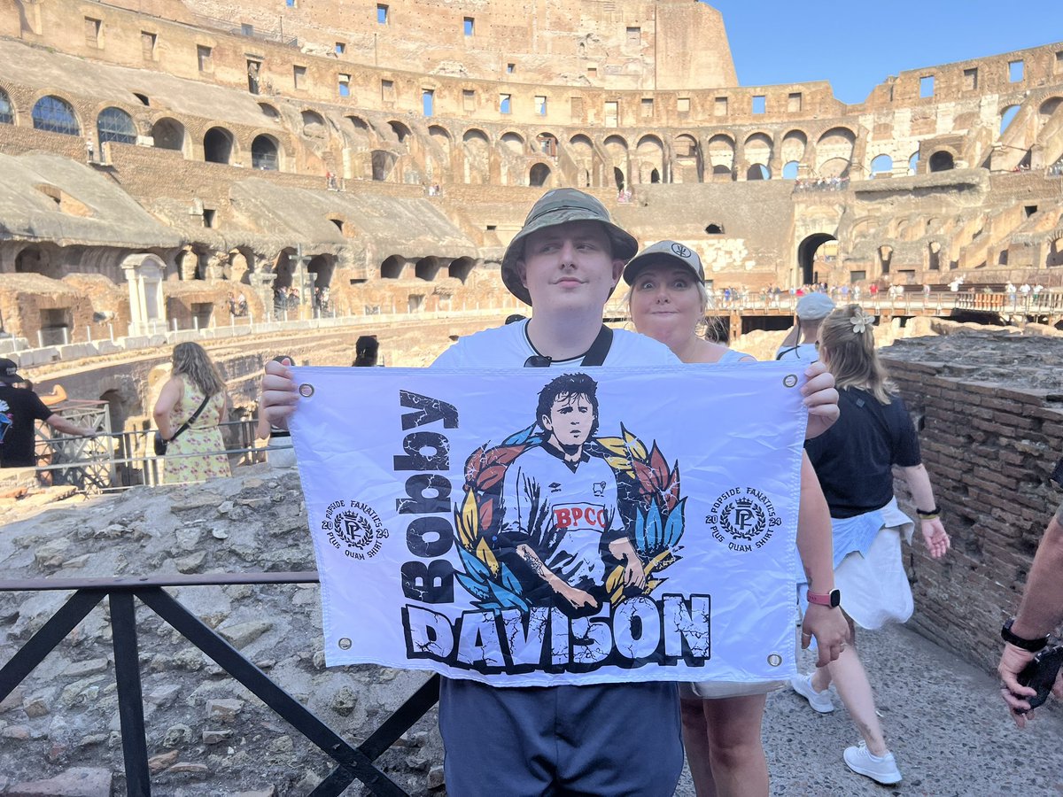 TheNickAllgood's tweet photo. .@PopsideFanatics my lad flying the flag in Rome. Photobombed by my other half.
#ramsontour #derbycounty https://t.co/Rca5pM5vky