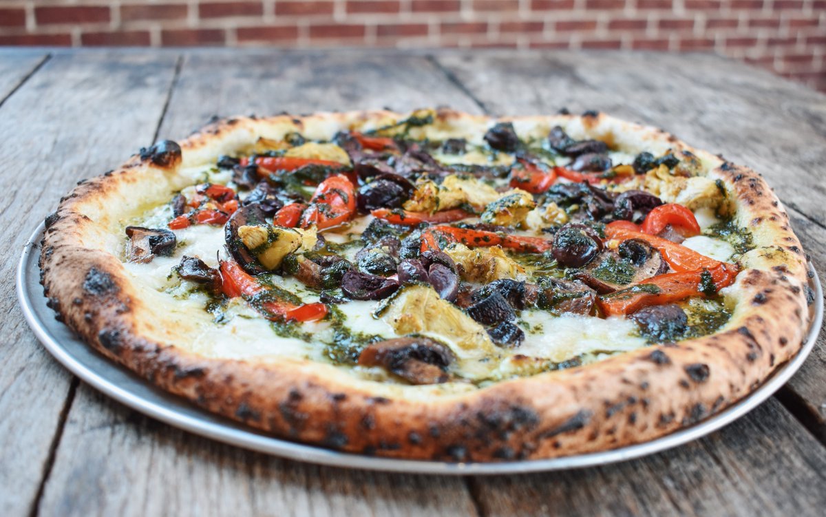 Our <a href="/thekrogdistrict/">The Krog District</a> exclusive Partenope pie is a veggie lover’s dream! Topped with fresh mozzarella, housemade basil pesto, roasted artichokes and peppers, mushrooms, Gaeta olives, Pecorino Romano, and basil, this veggie-packed pizza is full of flavor. 🍕