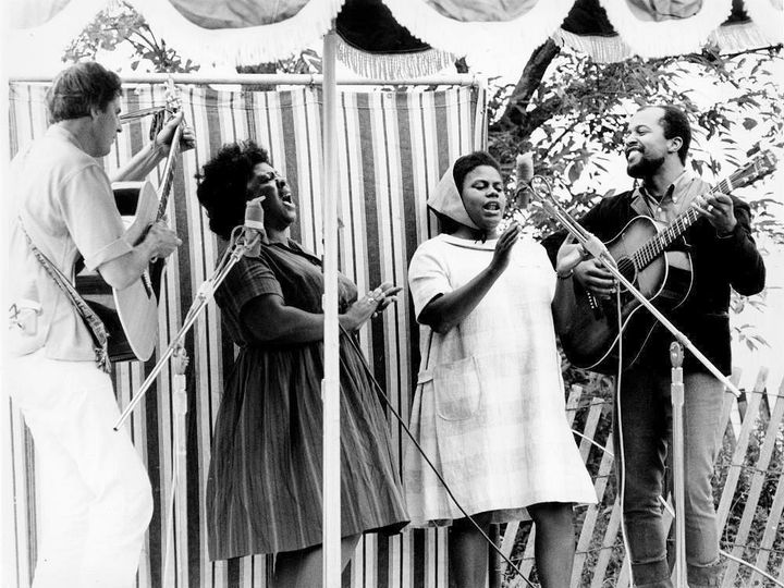 Fannie Lou Hamer and Bernice Johnson Reagon perform Freedom Songs at the Newport Folk Festival in 1965 with Guy Carawan (left) and Len Chandler (right). Photo by Diana Davies.
This archival video is featured in our film, Fannie Lou Hamer's America.