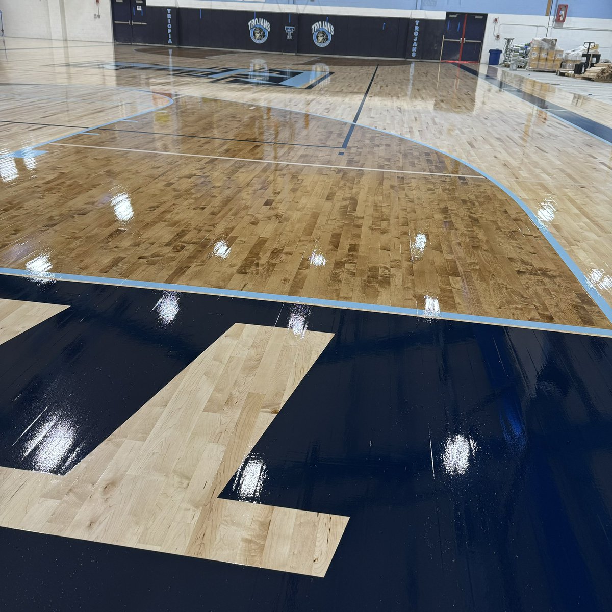 TriopiaCUSD27's tweet photo. Please see the attached photos of the painted gym floor. The last seal coat will be applied on Monday. After that, we are ready for the poured floor where the stage used to sit and then the new bleachers will be installed by mid-August. #triopia @OmniEP1 @MissouriFloor https://t.co/pCxDTg8D79