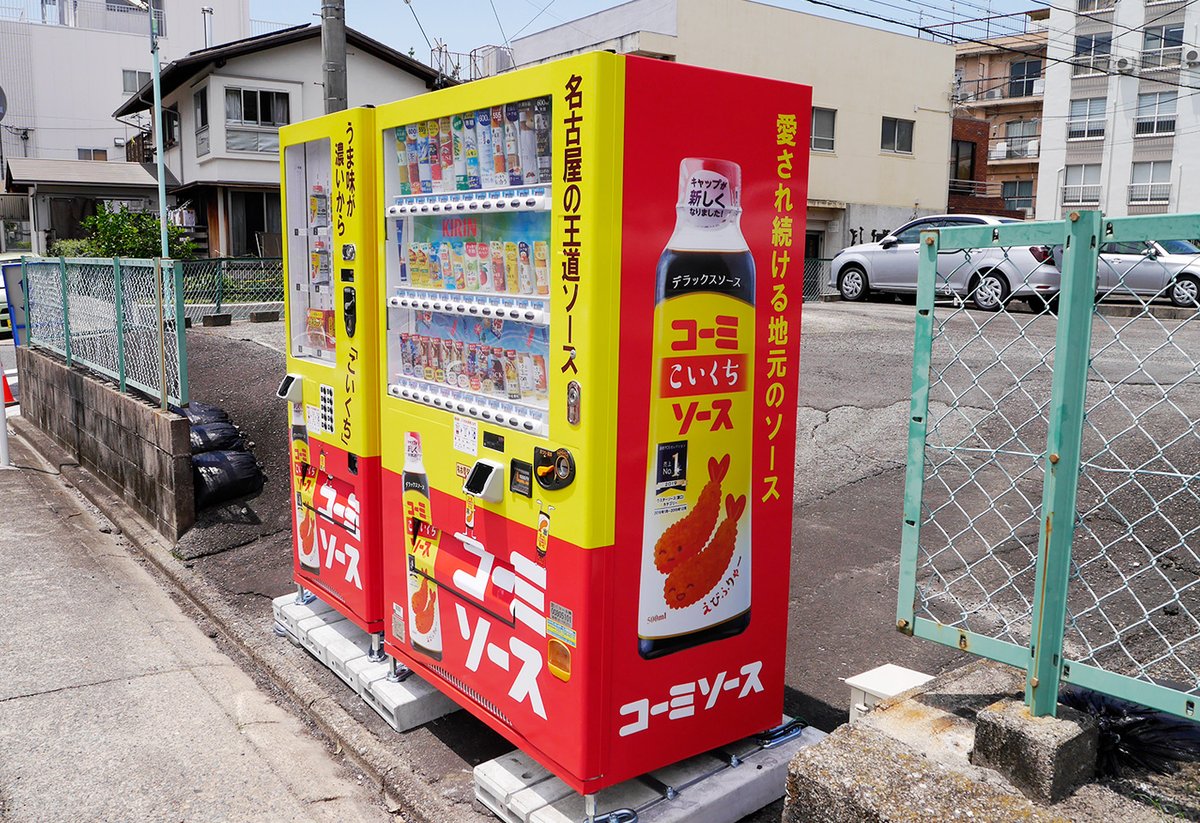 KOMI_SAUCE's tweet photo. コーミ『こいくちソース』の販売50周年を記念して、
コーミ本社前の駐車場に
🎊こいくちソースデコレーション自動販売機🎉が設置されたソース！
全国でここだけ⭐️スーパースペシャルレア⭐な自動販売機🤩

今だけの50周年限定パッケージの『こいくちソース』や
販売先限定の『味仙 台湾ラーメン』なども手に入るソース！

横から見ても、後ろから見ても、このインパクト！
コーミソースくんも見惚れてしまう自販機！

皆さまも、足を運んでくれたら嬉しいソース😘
（リポスト拡散も嬉しいソース！😍）