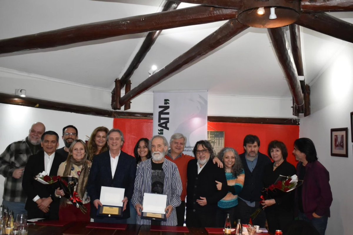 atn_chile's tweet photo. Un merecido homenaje le brindaron los autores de #ATN al dramaturgo Gustavo Meza y al abogado Santiago Schuster por su invaluable aporte en la creación de esta entidad en 1996. Desde entonces, ambos han dado una constante lucha por la protección de los derechos de los autores. https://t.co/PsW7rfGKyu