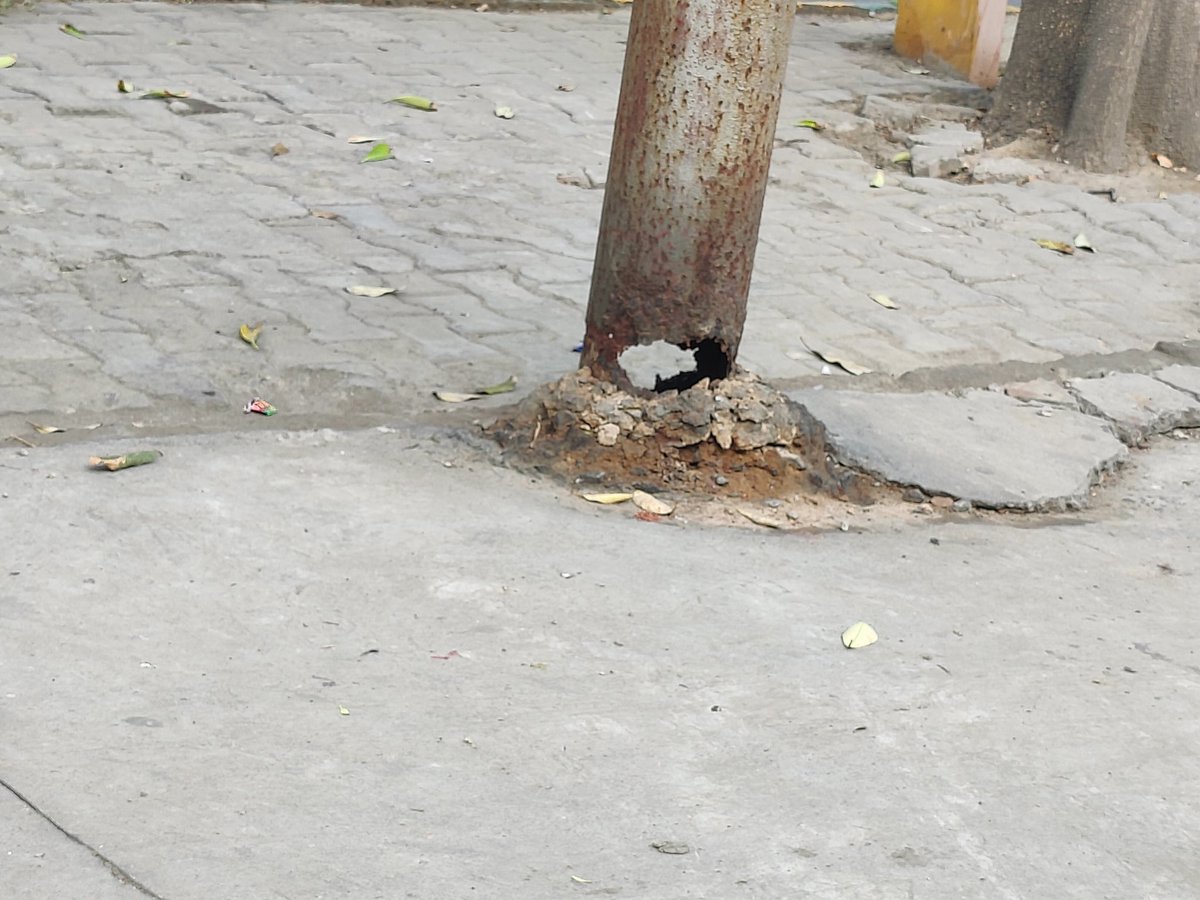 SarnathK's tweet photo. Lives at Risk, electricity pole without a base, right at the main gate of our society. The pole can fall any day in strong winds and cause loss of life and property... Concerned authorities are urged to take timely action. https://t.co/85e8wfDNB1
