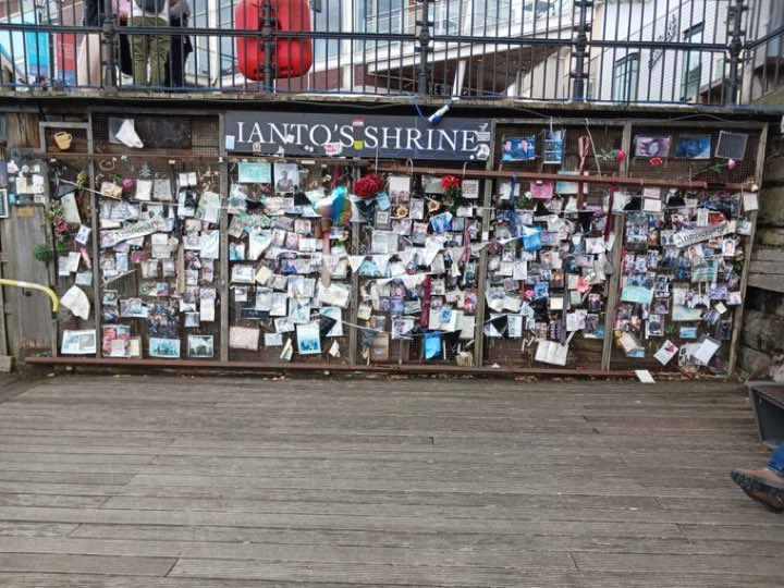 Save_IantoJones's tweet photo. Ianto’s Shrine looking better than ever after 15 years (2009, 2011, 2019, 2024). I think it’s time for #IantoJones to permanently come back to life post-COE! Thanks to @wallforianto &amp; @chinadO1172 for the 2009 &amp; 2024 pictures!  #SaveIantoJones #savethecoffeeboy  #sij15 https://t.co/mk6Ktw58oV