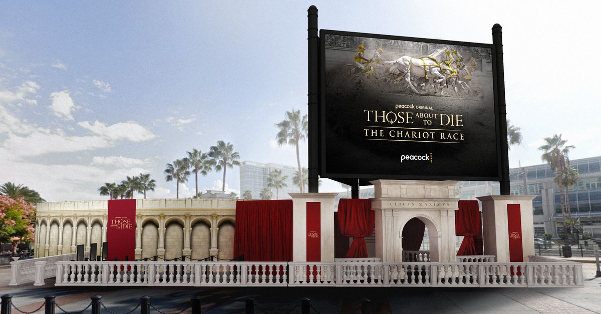 IGN's tweet photo. Peacock returns to #SDCC in a big way this month. Get the scoop on their two show panels, an epic chariot race activation, and plans to stream the Opening Ceremony of the #ParisOlympics to attendees: https://t.co/O9WeUw71EP

#ThoseAboutToDie #Teacup @peacock https://t.co/CWNfSHTG0k