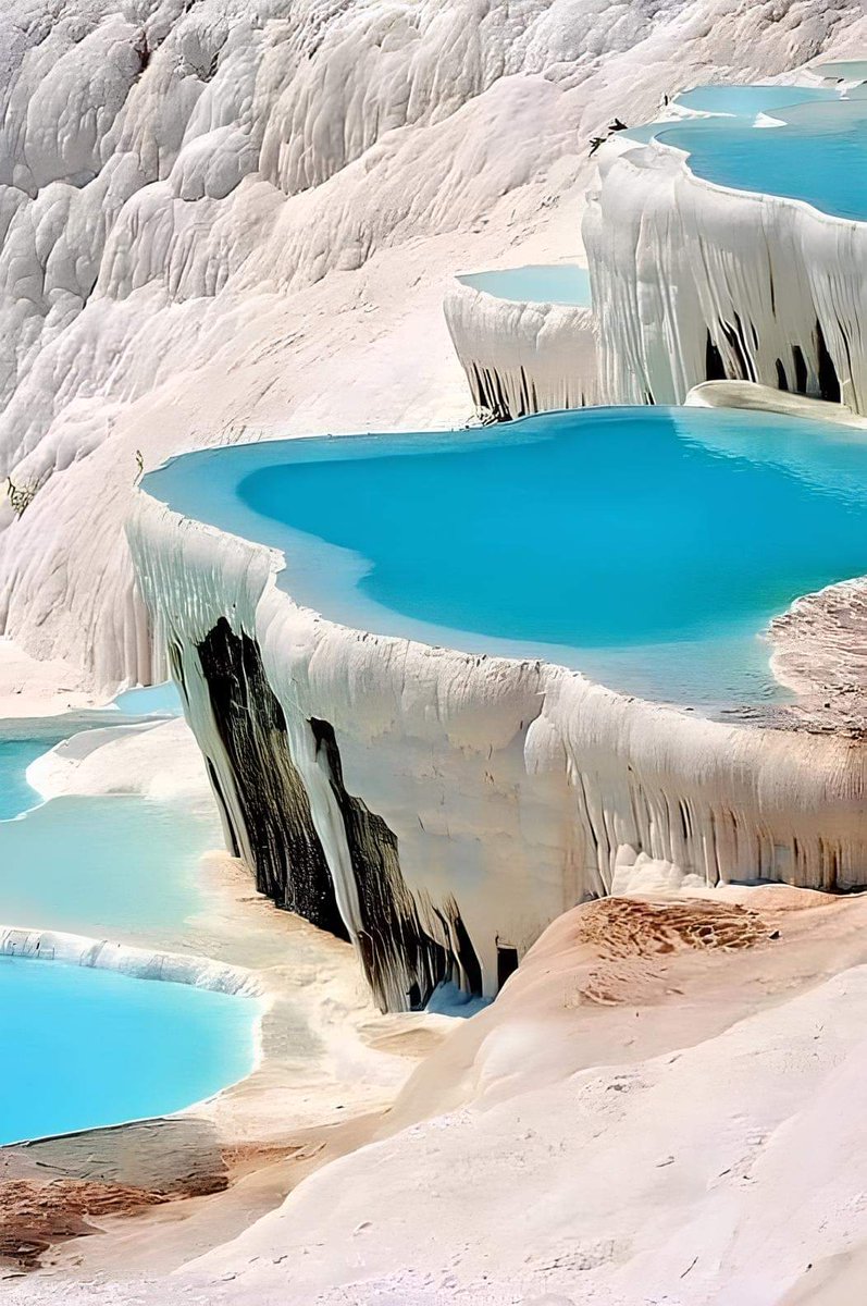 Pamukkale, or "cotton castle" in Turkish, is a stunning natural site in Denizli, southwestern Turkey. Shaped over millennia by calcium-rich springs, the snow-white limestone terraces resemble shimmering cotton, earning their name. Local legends say these formations are solidified
