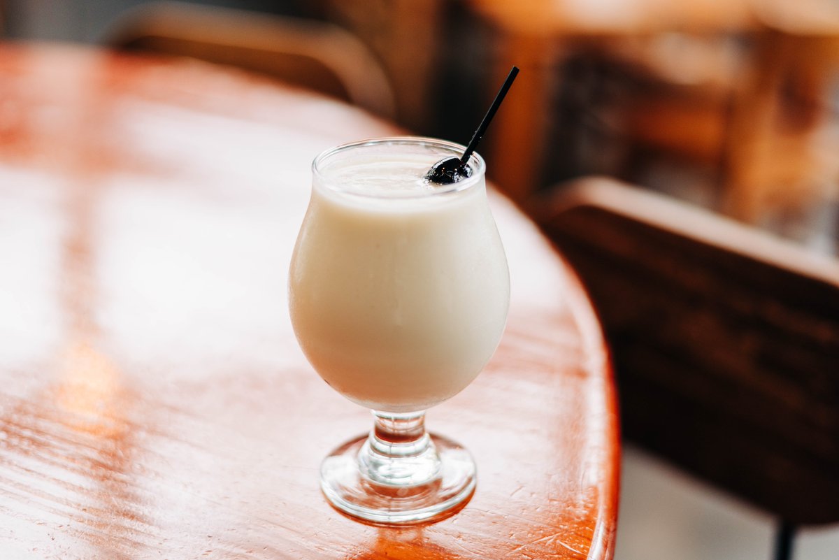 If you like #PiñaColadas... come enjoy this classic booze cruise bev tonight at #WarpedWing for #NationalPiñaColadaDay! With the weather today we may not be poolside, but we can manifest some #summer #beachvibes with this #classiccocktail in hand🍹