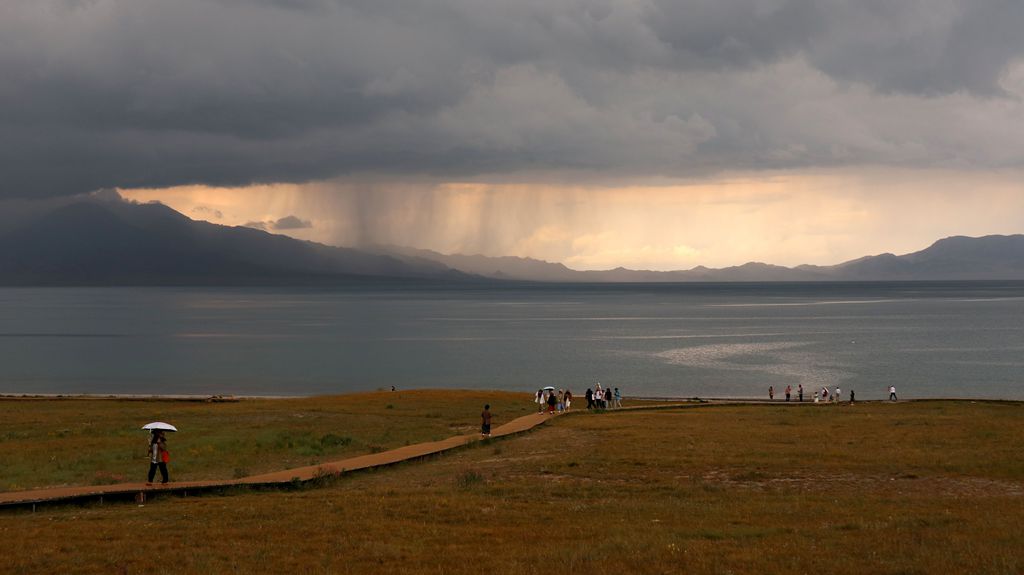 LUMaxime's tweet photo. Visited Sayram Lake，one of the most famous sites in Xinjiang.

作为伊犁河谷旅游路线必打卡点，赛里木湖，以往来过几次，都是晴天。

这次是我第一次在阴雨天看赛里木湖。

岸边野花草丛，远处乌云压顶、雨幕垂帘，又有仙境缥缈，伙伴们留影不少。 https://t.co/Tk8ogJvxyo