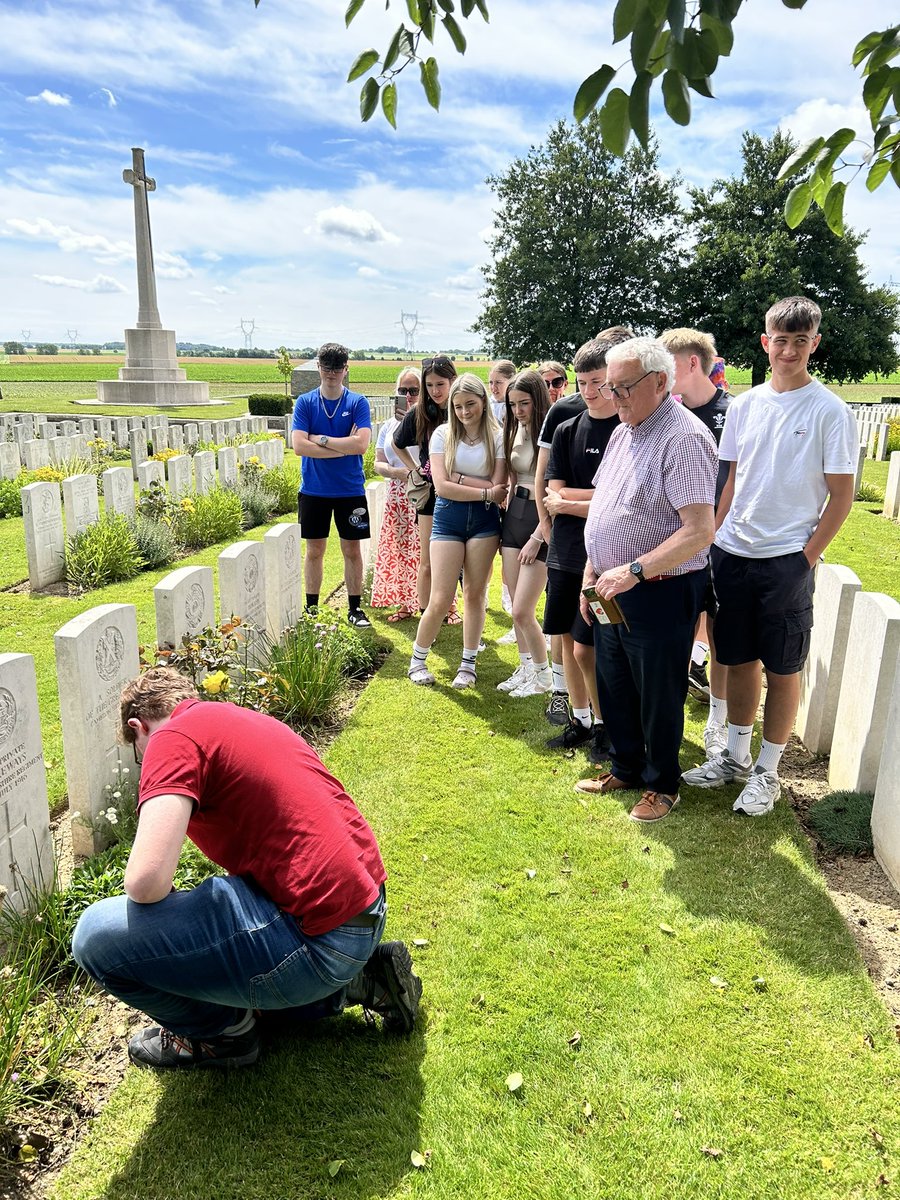 Oliver laying a cross at the grave of a relative today #islynhistorytrip2024
