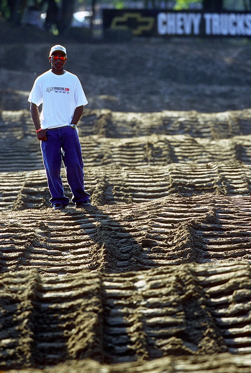 racerxonline's tweet photo. Over 20 years ago, a young James Stewart checking out the sand rollers of Spring Creek and we can only imagine thinking about letting that KX125 sing 🔥 @springcreekmx @promotocross #TBT 

📸 @cudby #ProMotocross #SMX https://t.co/os37os8tHC