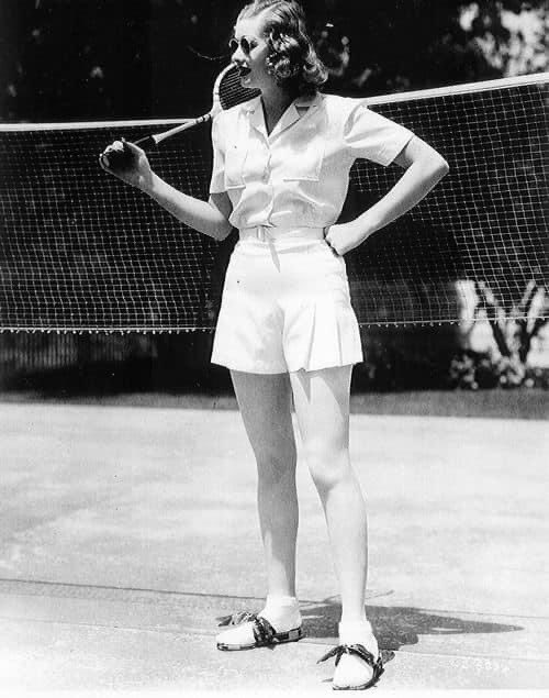 MuseumofCarpet's tweet photo. Playful piece from our 1940s display! Not quite vintage Wimbledon but not far off!  A cream button-fronted badminton outfit, faux silk, divided skirt &amp; pocket on the right. Standing on a first piece of carpet from loom with double grippers, Brintons Ltd, Gripper Axminster, 1946 https://t.co/4uIhLcAmuv