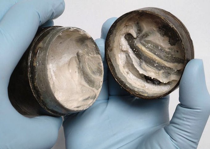 fasc1nate's tweet photo. 2,000-year-old face cream inside a metal container from Roman times with visible ancient finger marks. ⁣⁣  "The cream was found to be composed of refined animal fat, starch and tin.     

The researchers then created their own version, made to the same recipe.     

When they rubbed the whitish cream into their skin, it produced a white layer with a smooth powdery texture.   

The latter quality was created by the starch—still used for this purpose in modern cosmetics."⁣⁣ ⁣⁣     

According to Professor Richard Evershed from Bristol University:   

"White face paint was fashionable in Roman times and normally derived its colour from a lead compound. A tin compound would have been an acceptable substitute and in good supply from Cornwall."⁣⁣ ⁣⁣     

In ancient Rome, lead was by far the most popular metal and was commonly used in cups, plates, coins, pipes, cosmetics, face powder, paints, food seasoning, and even birth control.⁣       

Scientists have even discovered that tap water from ancient Rome contained up to 100 times more lead than that of local spring water.       

As a result, some historians have speculated that lead poisoning may have played a part in bringing down the Roman Empire.⁣⁣