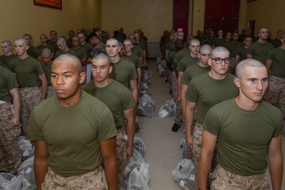 USMC's tweet photo. #MarineCorps recruits with Fox Company, 2nd Recruit Training Battalion, await further instruction as part of a receiving event at @MCRD_SD.

During receiving, the recruits are checked for contraband, given haircuts, make a scripted phone call home, and issued their gear. 

#USMC https://t.co/AtAas9pAJE