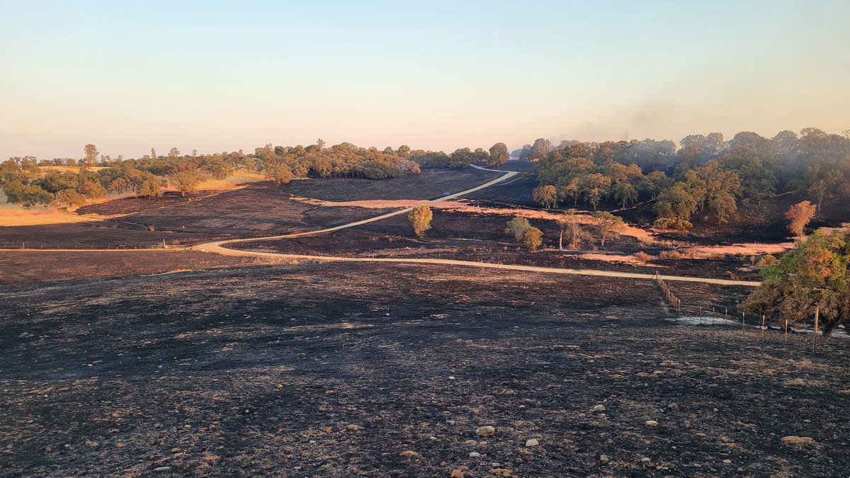 CALFIRE_ButteCo's tweet photo. #RailbridgeFire [update] The fire burned right to the edge of that #ApacheFire. The road going across the middle of the photo is the line between the two. In the foreground is the Apache Fire scar, and in the background is the new Railbridge Fire. https://t.co/HzarB9UqXC