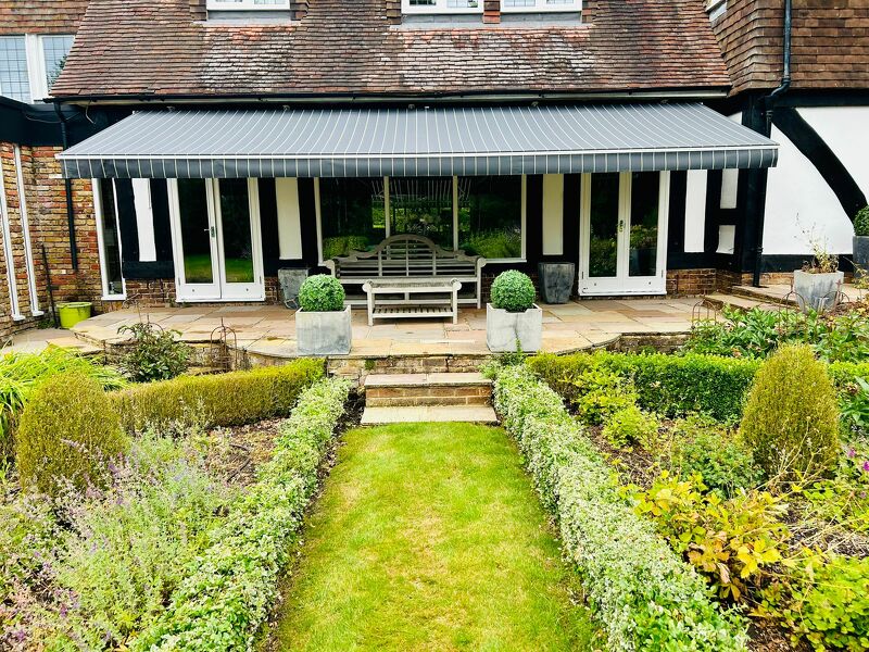This really pretty house in Oxshott, Surrey had a huge awning at nearly 8 metres wide which was in need of a spruce up.   It was taken away, cleaned, lubricated and repaired and now with a new eye catching canvas recover looks as good as new again. 
radiantblinds.co.uk/1-x-folding-ar…