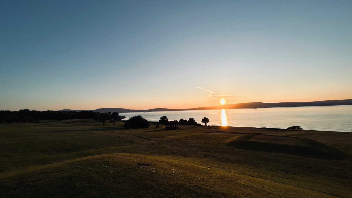 Sunset view from the 13th tee box overlooking the 12th and 9th greens. #sunset #twilightgolf #belfastlough #calm