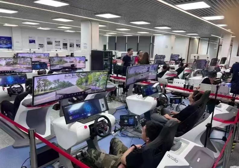 据说这是无人驾驶的士后台，可以远程操控无人驾驶车辆，我们可以看到实时路况，有方向盘、脚下还有刹车、油门等设备。在需要时可以及时人工干预！
我去应聘，不知道能不能顺利入职？😂