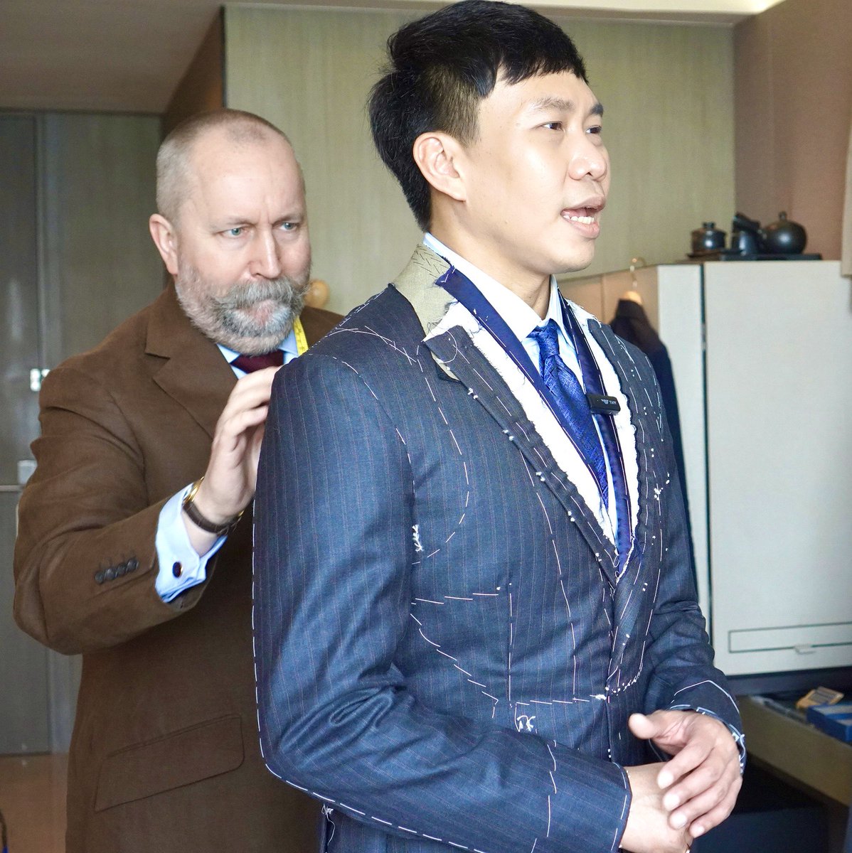 RobBaileyTailor's tweet photo. It takes a lot of concentration and experience to create a perfect finished bespoke garment.  Here our good friend Mr Martin Phu was receiving a first fitting in Bangkok in May. Later this month we return to give him his finished fitting 👌 https://t.co/pWblAWZN1d