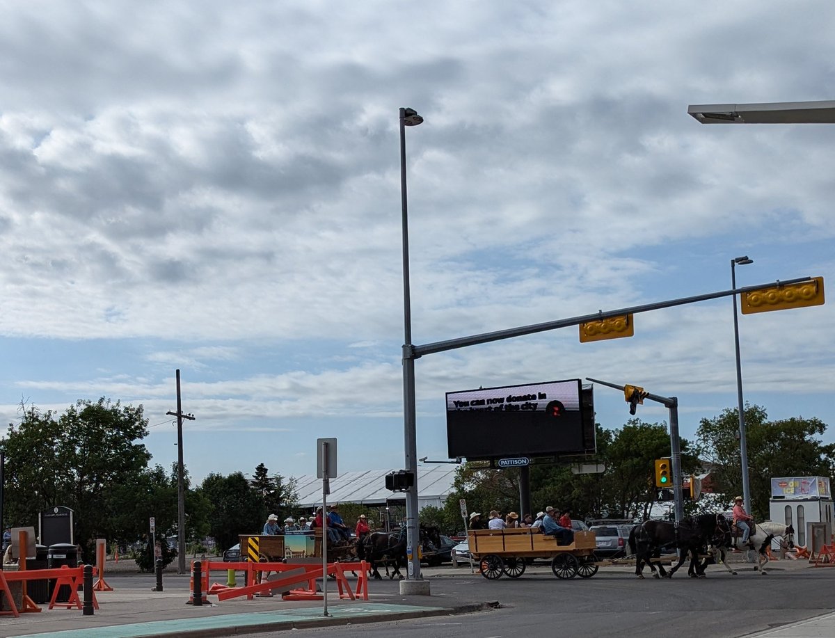 tzakowsky's tweet photo. Does it get more #CalgaryStampede than this?! Police closed the road this morning to allow a bunch of horse drawn wagons to make their way downtown. LOVE it! 🤠😍
#Stampede24 https://t.co/ays2zra3tH