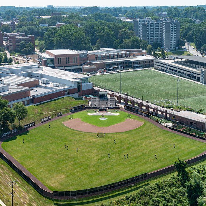 Our field is located in the heart of campus 

This allows for:

-An energized practice and game environment
-Thousands of people walking by during practices/games going between classes and the dorms
-Unique set up with a bridge running along and overlooking our field
