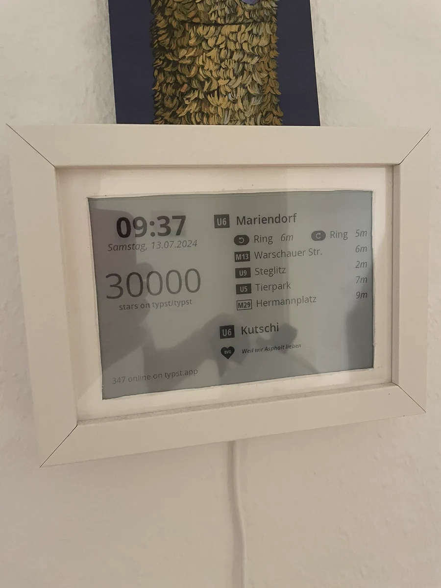 EPaper thingymabob showing exactly 30,000 stars on GitHub for typst, as well as some metro departures