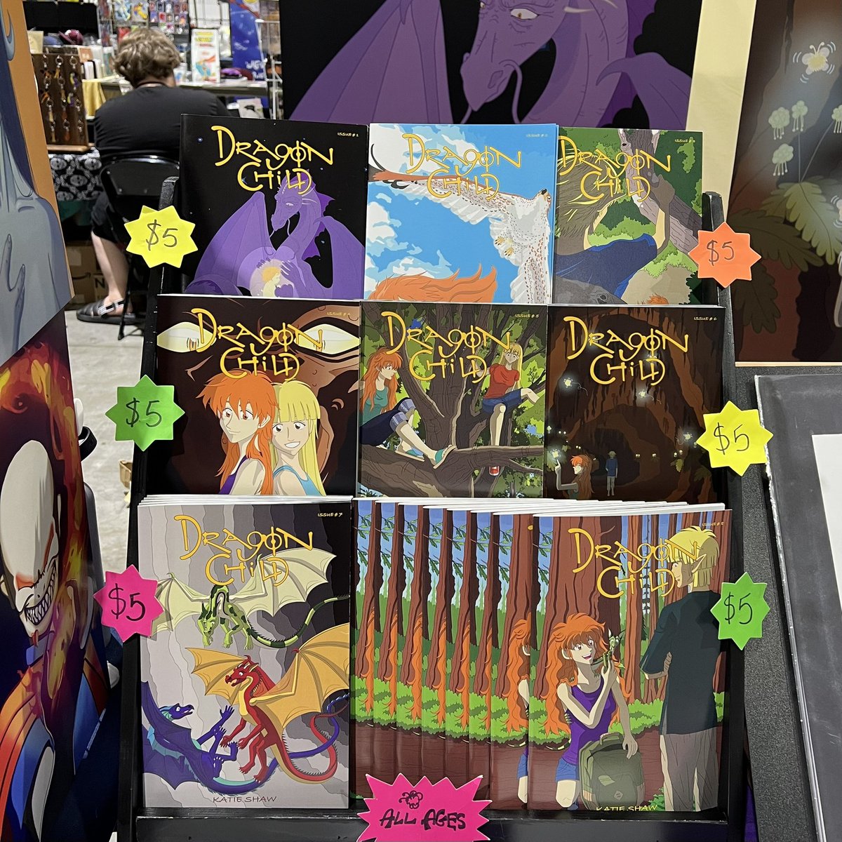 DragonChildKS's tweet photo. We’re at Silver Age Comic Con in the Reno-Sparks Convention Center.  If you’re in the Reno, NV area this weekend, come check out this fun event!  You can find us in Hall 5.  Look for the purple tablecloth and the tree full of dragons!

#silveragecomiccon #dragons #comics https://t.co/ptqR8P7Djy