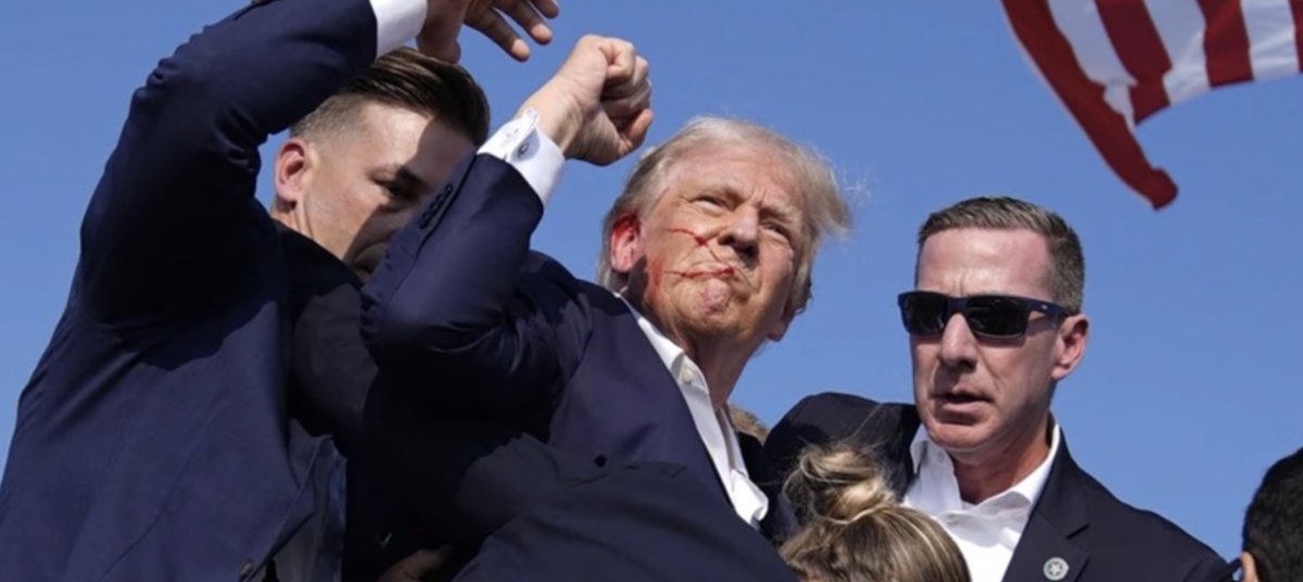 Trump shot but not seriously injured. 

An iconic photo, it has everything trump, bloodied face, defiant fist, American flag and a bj. Man’s a legend.