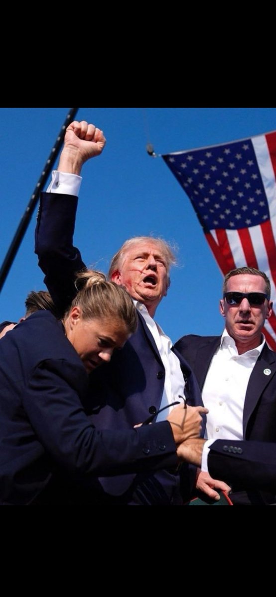 HattonScott's tweet photo. This will be the most iconic picture in  The history of the world!!! If you don’t think GOD had something to do with the bullet missing his head then you really need to find Jesus.  If you don’t support Trump after this please unfollow me and never speak to me in person 1000%. https://t.co/56DDlj4hdT