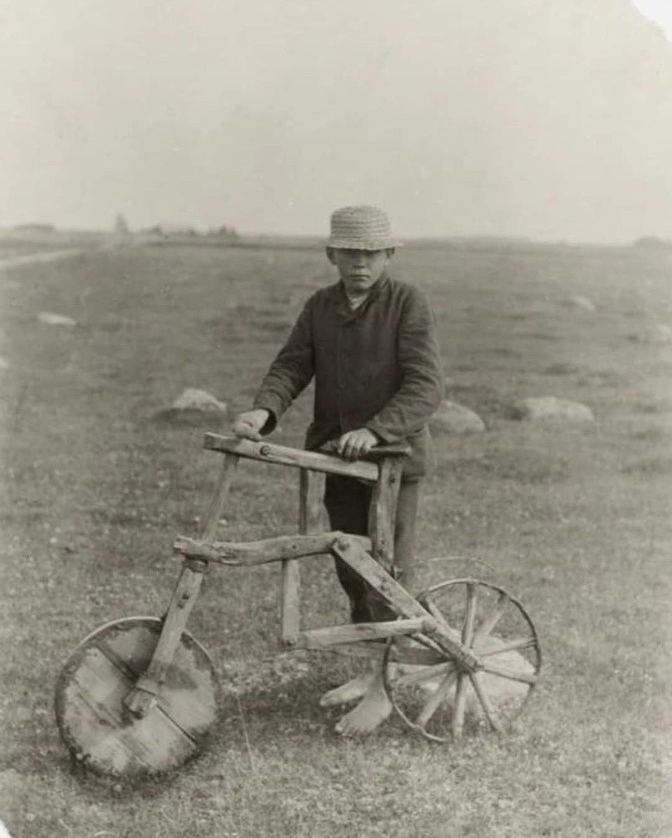 dionysius_80's tweet photo. A boy from a poor family with a homemade wooden bicycle, 1912. https://t.co/oXRyWOmiFr