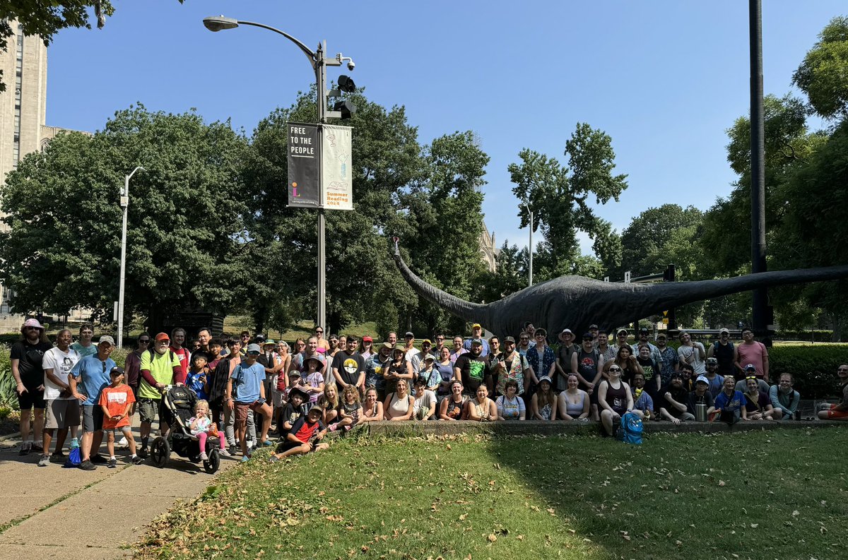 Day 1 of #PokemonGOfest2024 was a total blast! The Panther’s Den (Pittsburgh, PA) had to include Dippy the Dinosaur in our group photo to celebrate her 125th birthday! Love our local Oakland celebrity! #CommunityAmbassador #carnegiemuseumofnaturalhistory