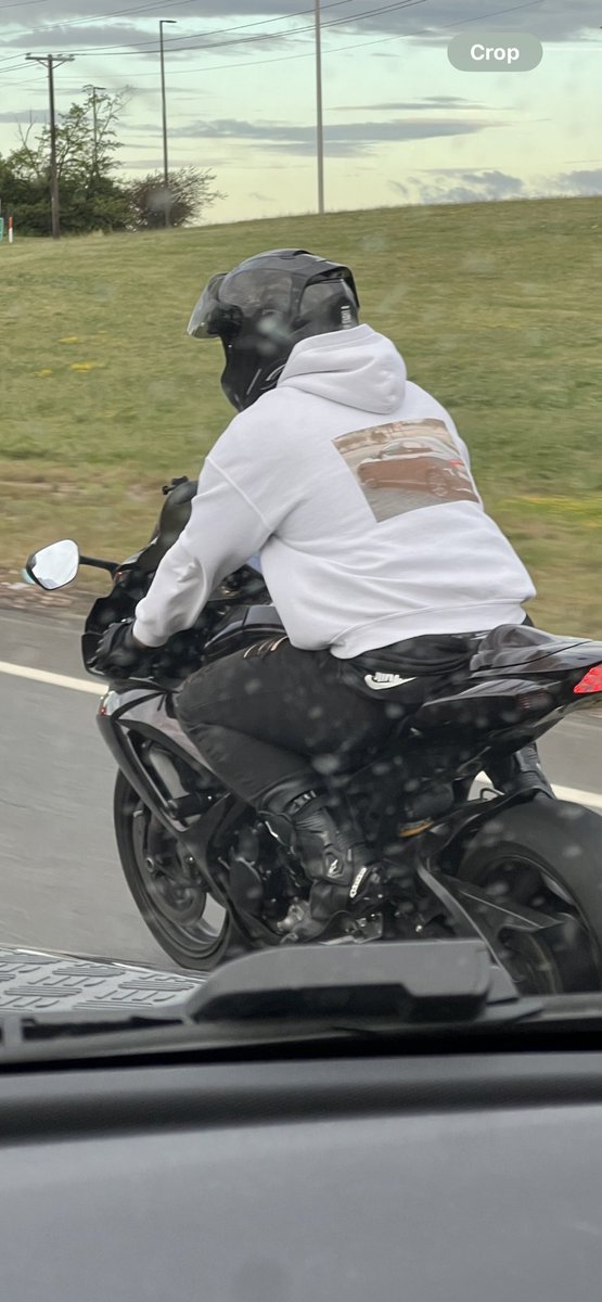 This dude riding a bike wearing a hoodie with a car on it 🤨